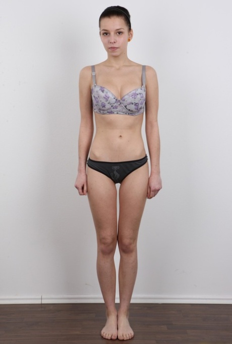 Young brunette peels away her jeans and bra to stand in her birthday suit