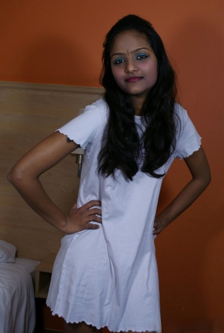 Indian female Divya lifts up a white dress to expose her vagina