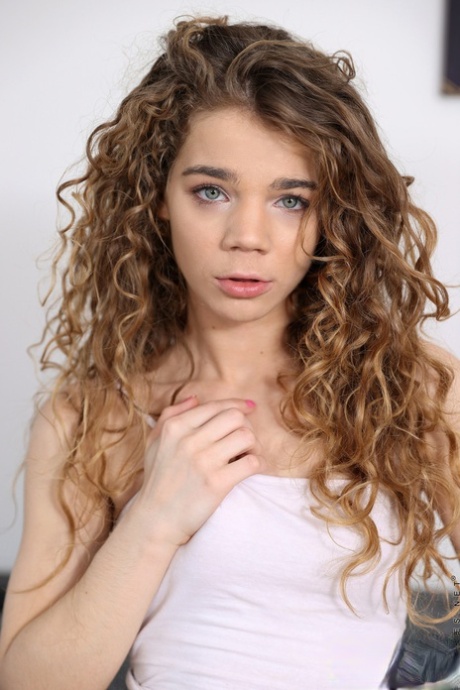 Curly haired teen Sabrina Spice displays her meaty pierced pussy and sexy feet