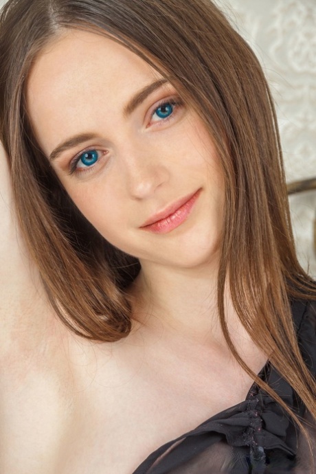 Blue eyed teen Nessie flaunts her nice tits and shaved pussy on a bed