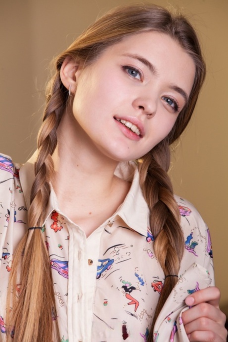 Pretty teen with pigtails Sigrid exposes her delicious pussy and long legs