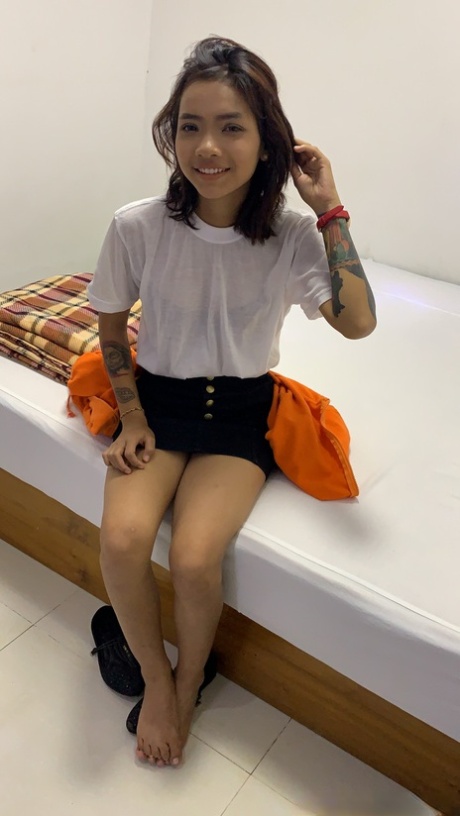 Cute amateur slut Emelyn stripping and exposing her inked body in a solo